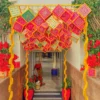 Artistic ceiling hanging decor with vibrant pastel drapes and traditional elements for Lohri celebrations.