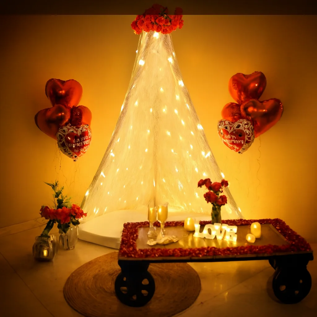 Romantic anniversary canopy decoration with fairy lights, red heart balloons, flowers and illuminated LOVE letters