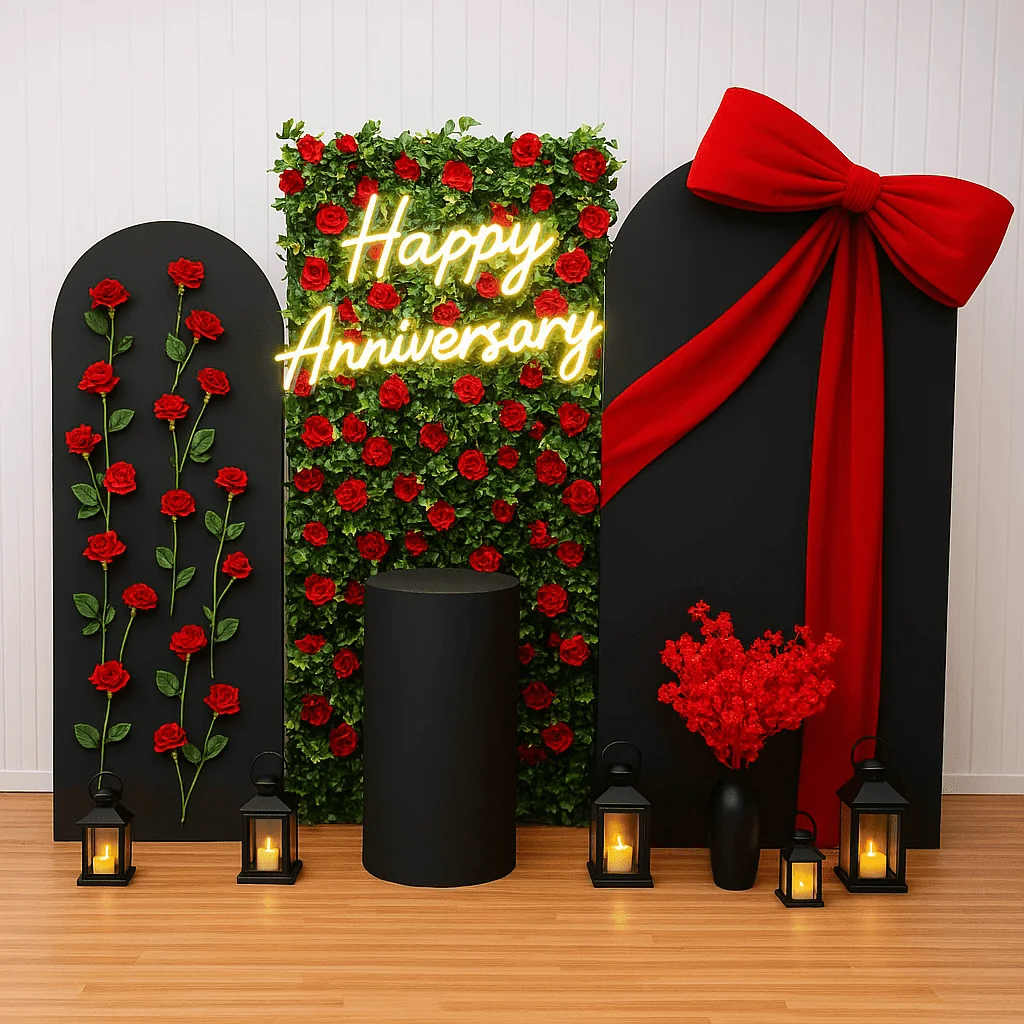 Red and black anniversary decoration with rose wall, Happy Anniversary neon sign, lanterns and oversized bow