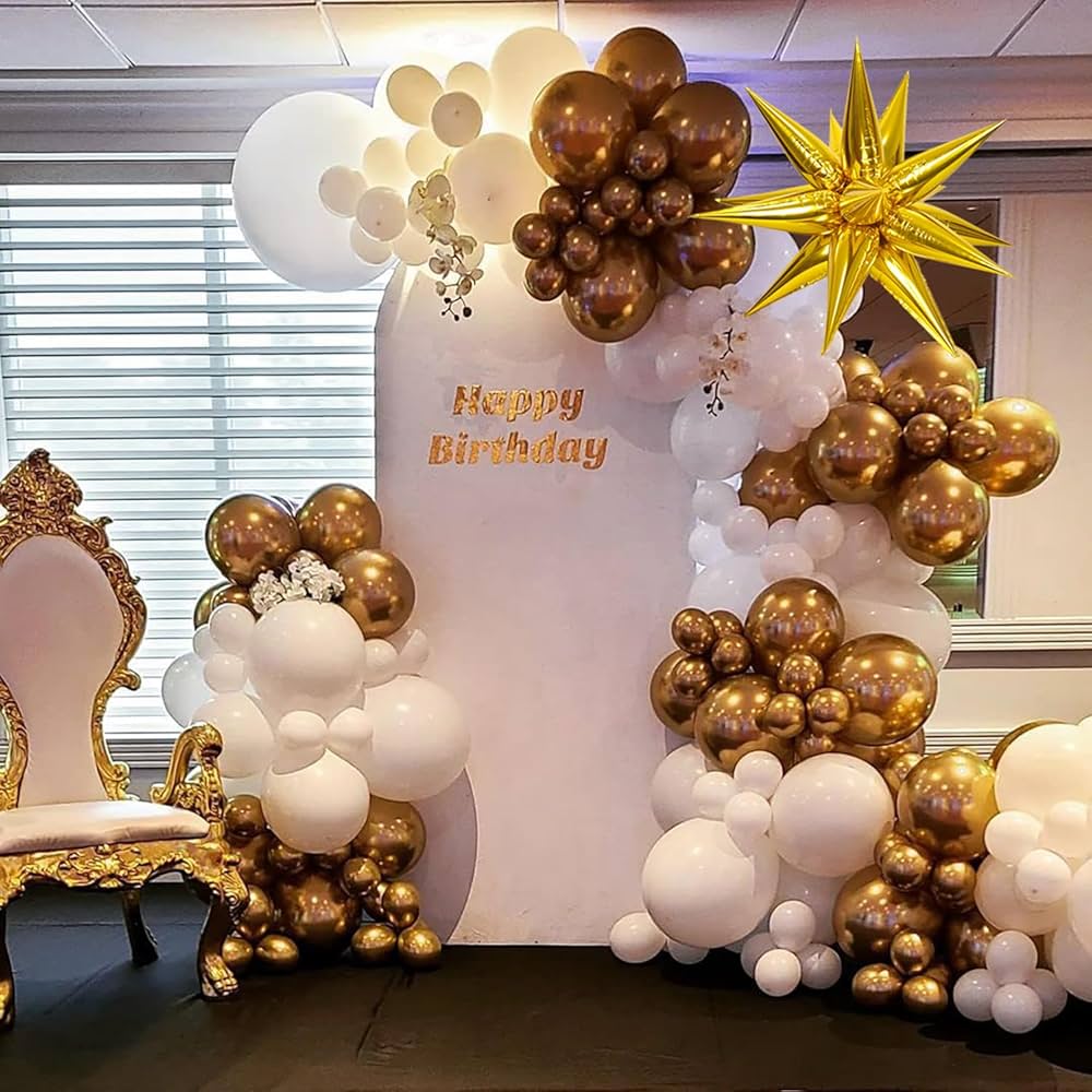 White and rose gold balloon backdrop with metallic balloons, gold starburst and ornate chair