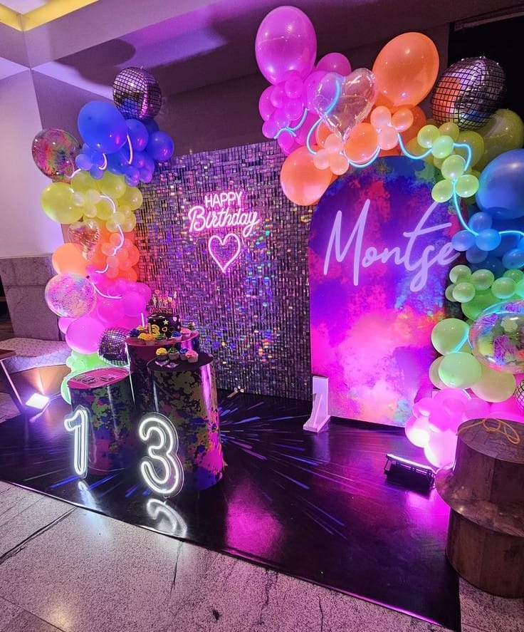 Birthday decoration at home with neon backdrop and stylish balloon setup