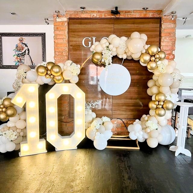 golden and white ring backdrop 10th anniversary decor