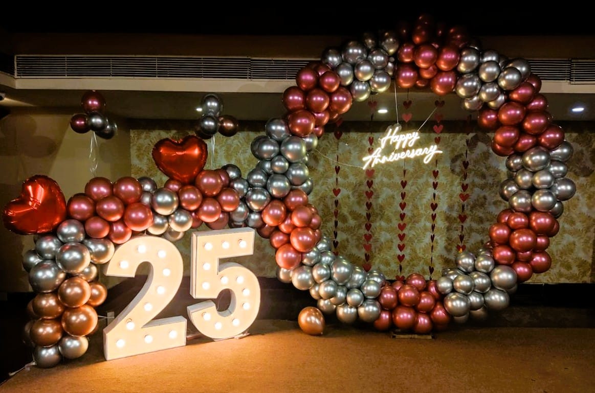 pink and silver ring backdrop with neon lights 25th anniversary decor
