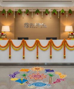 Alternative office reception styling with orange and yellow garlands, leaf-and-flower hangings, decorative pots and colourful floor rangoli