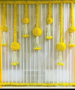 Alternative white sheer backdrop with yellow side drapes and suspended yellow-and-white floral hangings